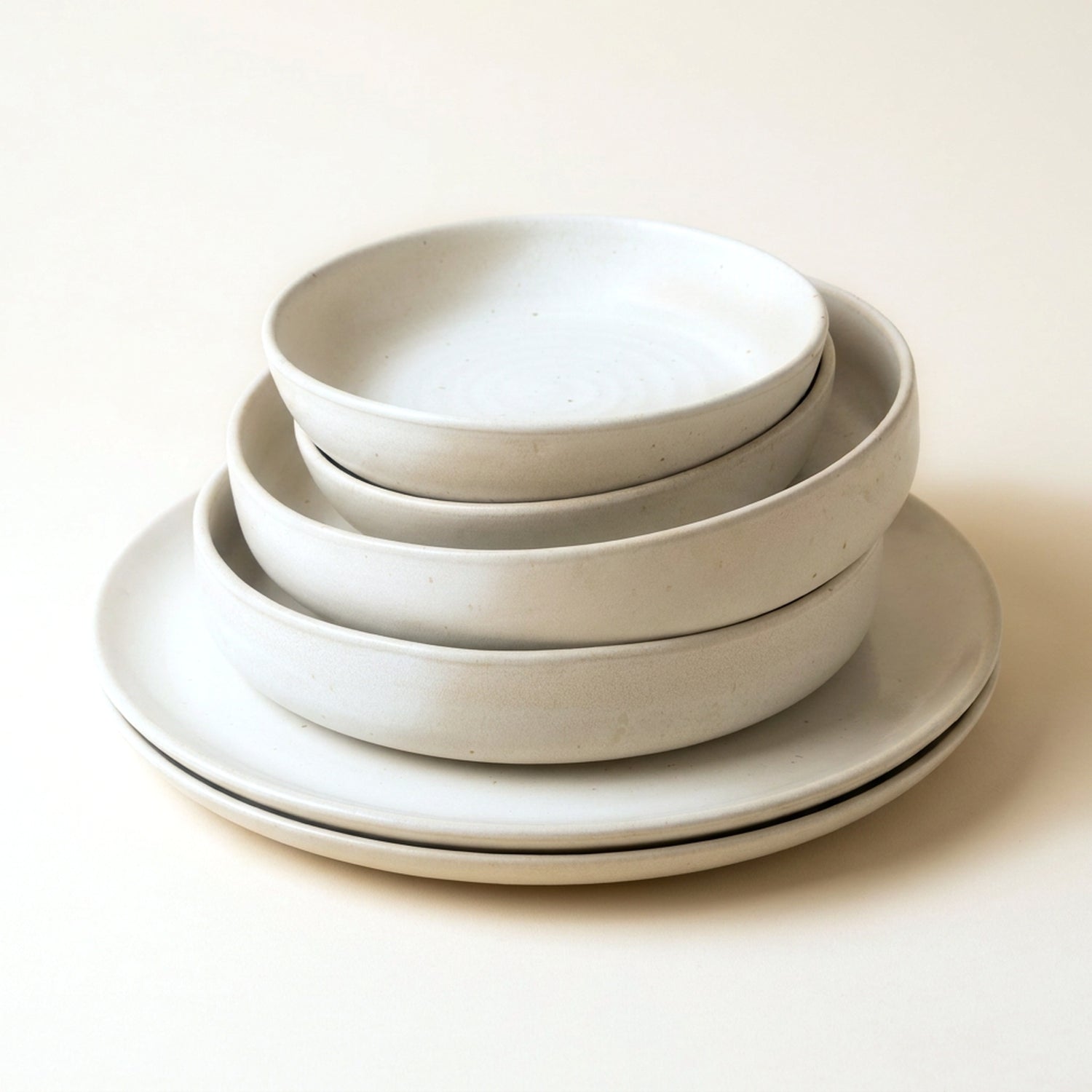 Table for Two set — six pieces of hand-glazed natural white stoneware, stacked: two large plates, two deep plates, two dessert plates